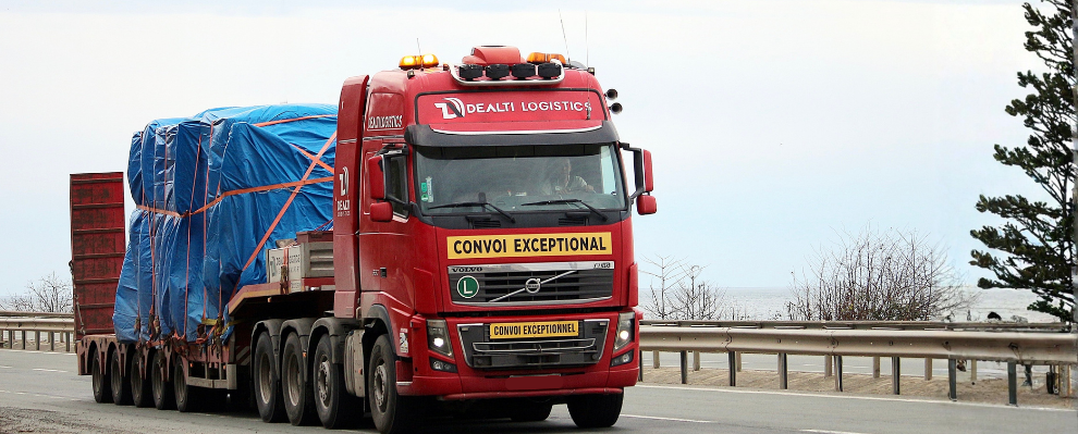 Lowbed trailer transporting heavy and oversized cargo on international road